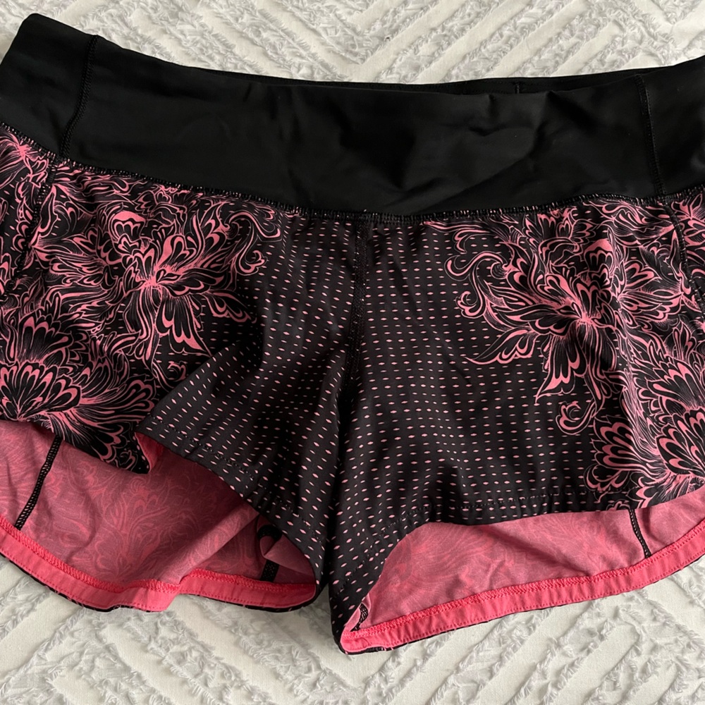 Lululemon Speed Up Low rise shorts in a cool black and pink floral print